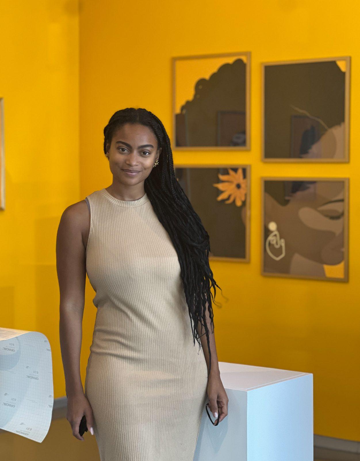 “Curls &amp; Coils” creator Maya Alia at the exhibit’s opening on Sept. 12, held at the Harvard Ed Portal’s Crossing Gallery in Allston. Alia’s mission was to celebrate Black women’s hair and empower them to embrace their natural hair. COURTESY OF MILES PERRY